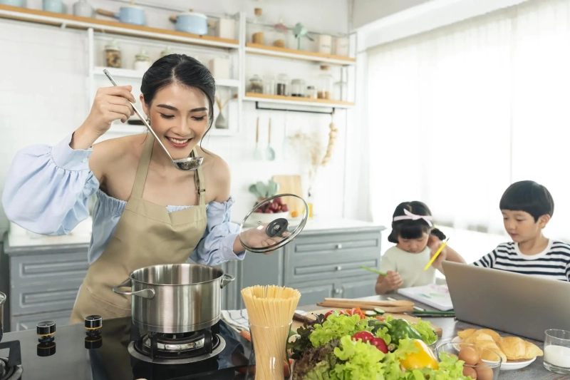 asian-young-single-mother-making-food-while-taking-care-child-kitchen_74952-2074_result
